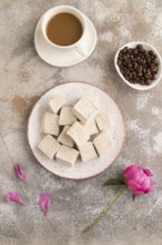 Coffee marshmallow with cup of coffee on brown concrete background. top view, flat lay, close up