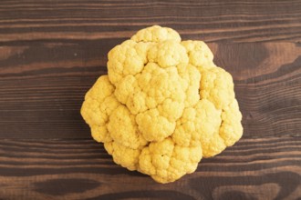 Yellow Cauliflower on brown wooden background. Top view, close up, flat lay. healthy food,