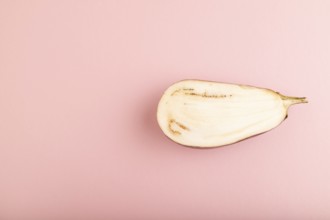 Purple Cutted eggplant with white stripes on pink pastel background. Top view, flat lay, copy space