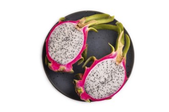 Ripe Pitaya on blue plate isolated on white background, top view, flat lay, close up, minimalism