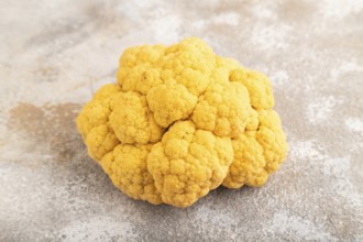 Yellow Cauliflower on brown concrete background. Side view, close up. healthy food, vegetable,