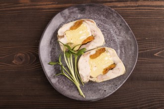 Chicken, egg and dried apricot meatloaf, microgreen on brown wooden. Diet, healthy eating. top