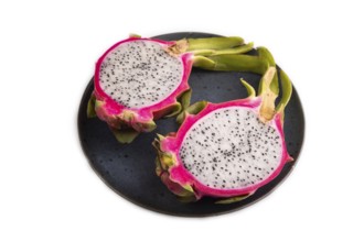 Ripe Pitaya on blue plate isolated on white background, side view, flat lay, close up, minimalism