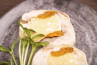 Chicken, egg and dried apricot meatloaf, microgreen on brown wooden. Diet, healthy eating. side