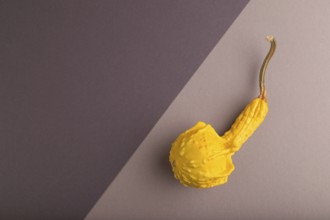 Decorative orange Pumpkin on beige and gray pastel paper background, top view, flat lay, copy