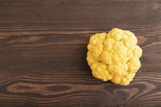 Yellow Cauliflower on brown wooden background. Top view, copy space, flat lay. healthy food,