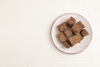 Chocolate marshmallow on white wooden background. top view, flat lay, copy space