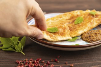 Fried homemade Khachapuri cake with cheese and meat, fried in pan with hand. Traditional Georgian