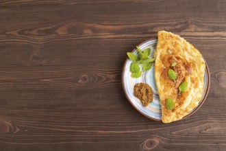 Fried homemade Khachapuri cake with cheese and meat, fried in pan. Traditional Georgian cuisine on
