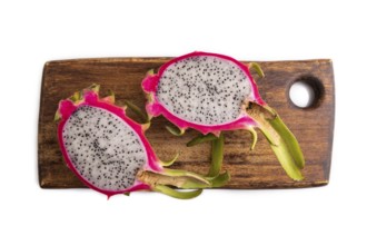 Ripe Pitaya on cutting board isolated on white background, top view, flat lay, close up, minimalism
