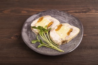 Chicken, egg and dried apricot meatloaf, microgreen on brown wooden. Diet, healthy eating. side