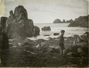 Magic lantern slide two boys playing on rocky beach circa 1900 location not known, presumed to be