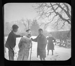 Magic lantern slide c 1900-1910 of children making a snowman in garden