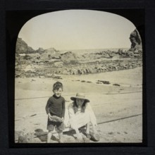 Magic lantern slide two children playing on a sandy beach circa 1900 location not known, presumed