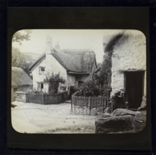 Magic lantern slide of white thatched village cottages in rural location possibly Wessex, England,