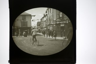 People gathering for a patriotic event with bunting flags across the street, possibly Edinburgh,
