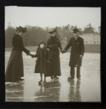 Magic lantern slide well-dressed middle class Edwardian family ice skating England, UK c 1900-1910