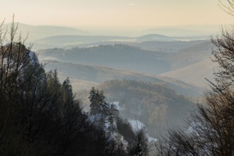 View over the hills and valleys from the mountain with hoarfrost on the branches in winter, Vápec,
