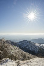 View over the hills and valleys from the mountain with hoarfrost on the branches in winter, Vápec,