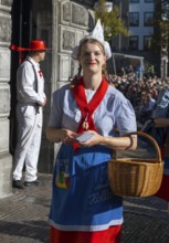 Woman in traditional Dutch dress with basket on sunny day, cheese market, Alkmaar, Alkmar,