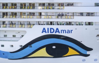Close-up of an AIDA cruise ship with balconies and striking blue and yellow livery, Warnemünde,