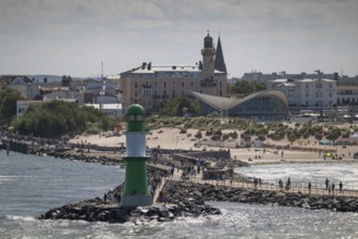 Green-white lighthouse, pier light Westmole, hotels in the background, Warnemünde, Rostock,