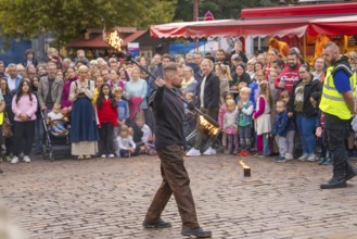 A fire juggler impresses the audience with his tricks on a busy square, Feuernacht, Sindelfingen,
