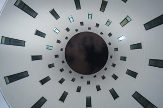 View upwards to circularly arranged windows in a modern building, Munich, Germany