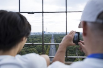 Two people photographing the start of the 51st BMW Berlin Marathon 2025 on 21 September 2025 from