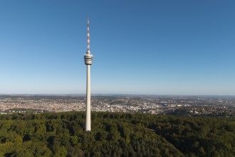Television tower rises above a wooded area against an urban backdrop, Stuttgart, Baden-Württemberg,