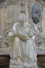 Seated white female figure reading a thick book as a symbol of science, allegory, knowledge,
