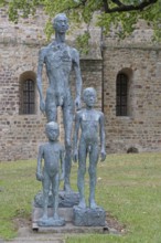 Sculpture Standing and Resting Group by Sabine Grzimek 1985, standing naked slender male figures,