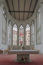 Chancel with colourful stained glass windows and altar, interior view, St. Petri Church, Magdeburg,