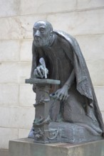 Albertus Magnus by Heinrich Apel 1985, medieval scholar and bishop writing with quill, view, bronze