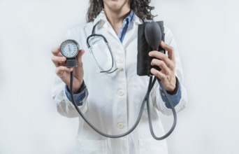 Doctor hands showing blood pressure monitor isolated. Close up of Doctor showing tensiometer