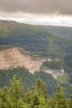A quarry on a wooded hillside under a grey sky, Black Forest, Seebach, Germany