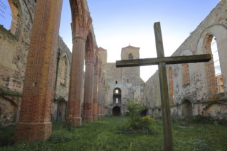 Interior view of the St. Nikolai church ruins, cross, green lawn, nature, empty, twin towers,