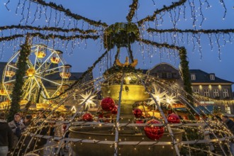 Christmas market at the market fountain in Goslar at dusk, Lower Saxony, Germany