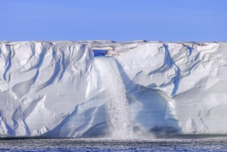 Waterfall at edge of the Brasvellbreen glacier from the ice cap Austfonna debouching into the