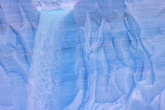 Waterfall at edge of the Brasvellbreen glacier from the ice cap Austfonna pouring into the Barents