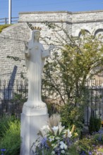 Hawthorn bush and statue of Virgin Mary in front of bridge at Our Lady of Beauraing, Notre-Dame de