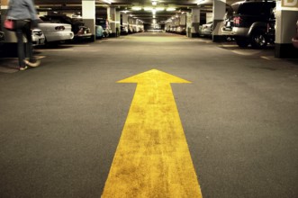Yellow arrow in a car park in Manhattan, New York City, USA