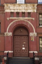Historic school building with separate school entrance for boys, New York City, USA