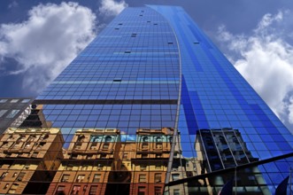 Reflection in the glass façade of a skyscraper, New York City, USA