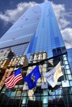 Skyscraper façade with flags and reflection in the glass façade, New York City, USA