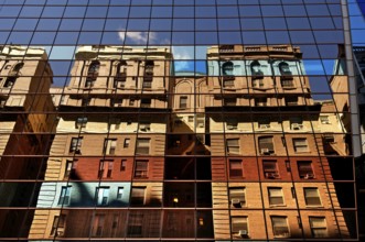 Residential buildings reflected in a high-rise façade, New York City, USA