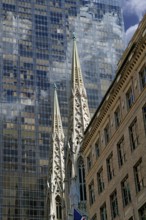 Towers of St Patrick's Cathedral in front of the facade of a skyscraper, Manhattan, New York City,