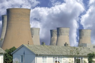 Cooling towers of a coal-fired power station next to a residential neighbourhood, Midlands,