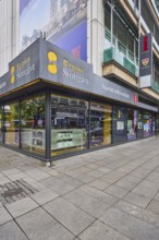 Tourist information centre, building, shop window, pavement made of paving slabs, pedestrian zone,