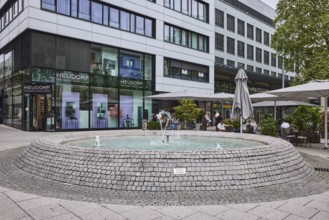 Cobblestone fountain, fountain, water, pedestrian zone, general architecture, shop window, outdoor